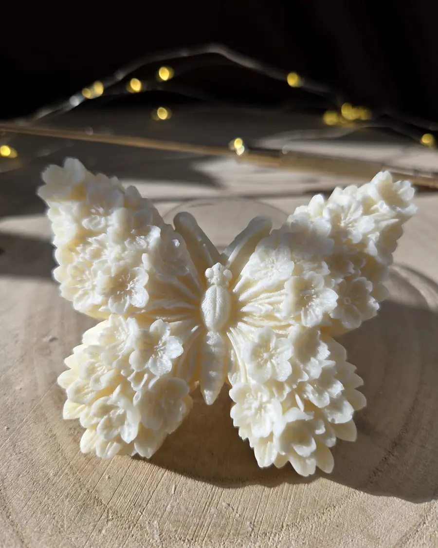 Ivory butterfly candle with wings made of tiny flowers