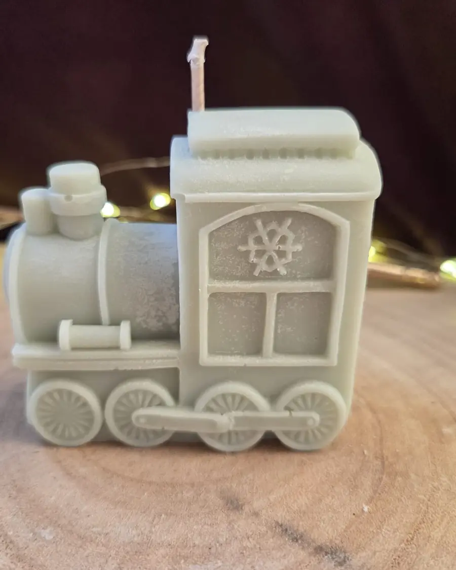 Sage grey train engine candle on a wood slice