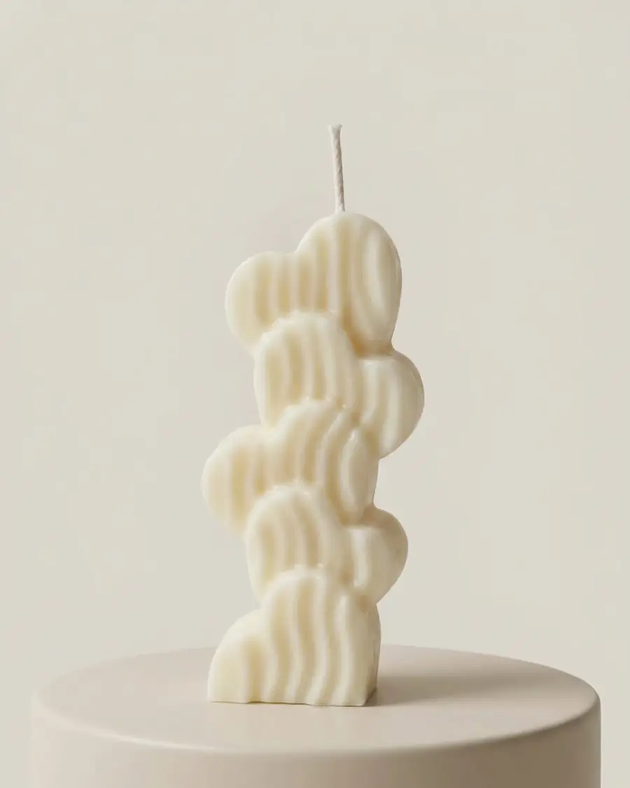 Ivory stacked candle of wavy blooms on a stand