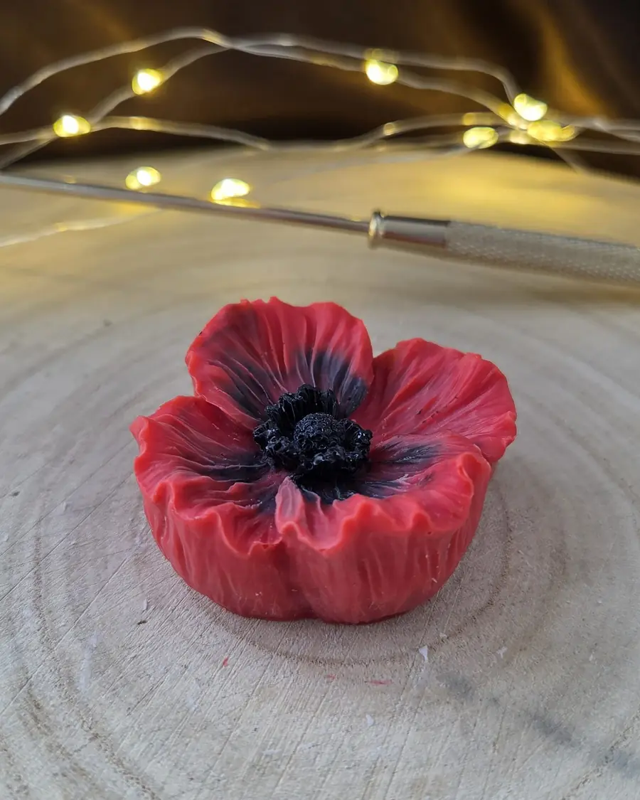 Red poppy candle with a black centre