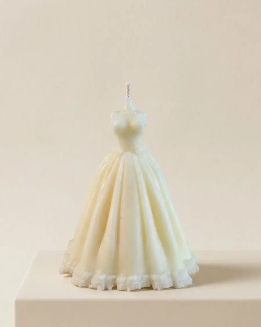 Ivory wedding dress candle with a flared lace-trimmed skirt
